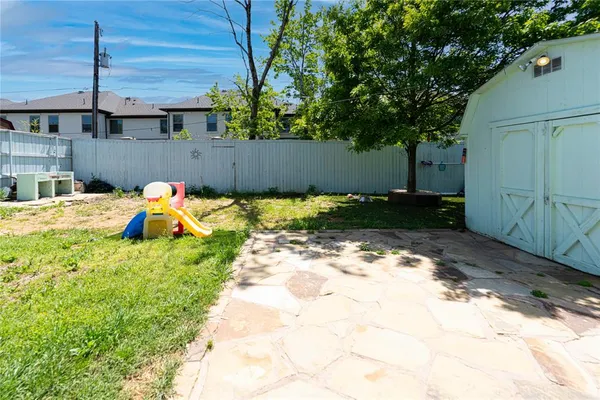 a backyard of a house with a table and chairs