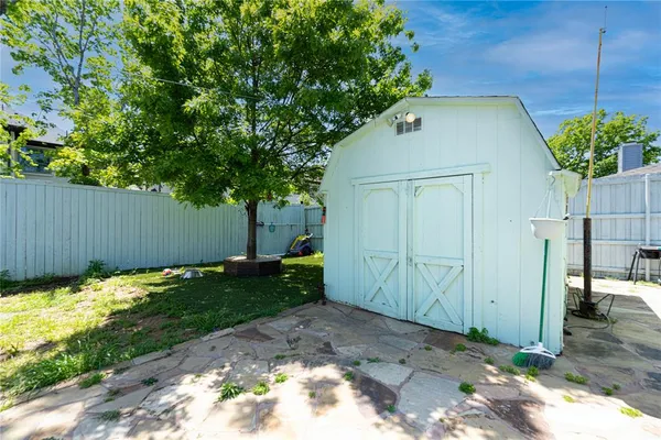 a backyard of a house with plants and trees