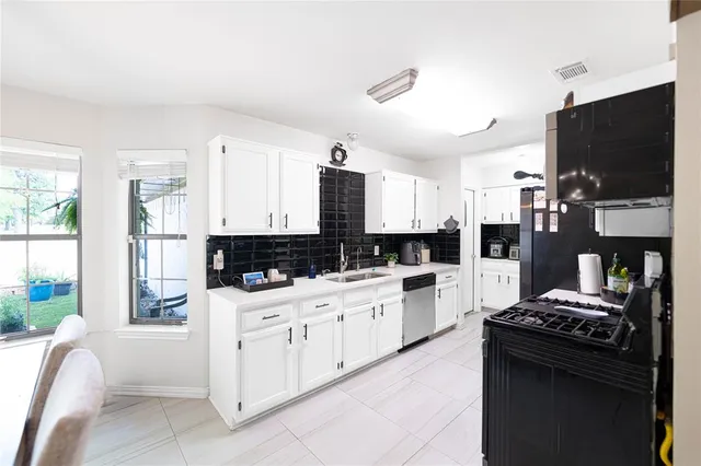 a kitchen with a stove a refrigerator and a sink