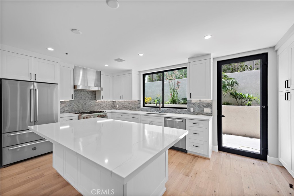 33901 Robles Drive Dana Point, CA 92629 - Photo 3 of 12 a large kitchen with kitchen island a large counter top space a sink stainless steel appliances and cabinets