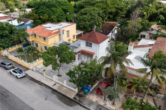 an aerial view of residential houses with outdoor space and street view