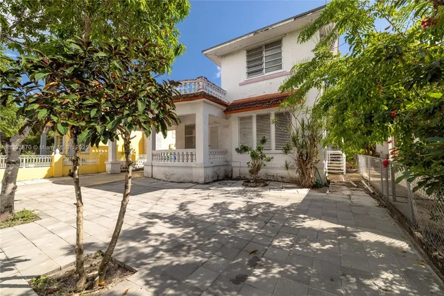 a view of a house with snow on the road