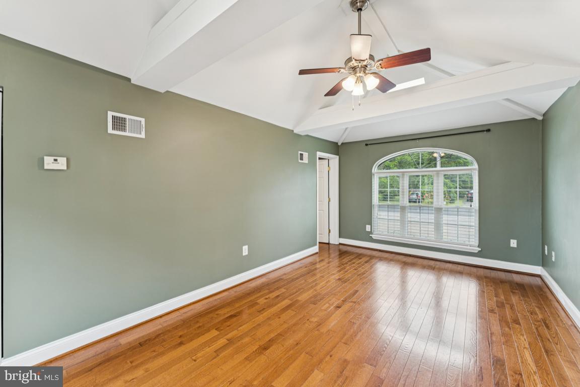 5 Brookfield Road Pasadena, MD 21122 - Photo 12 of 34 a view of an empty room with wooden floor and a window
