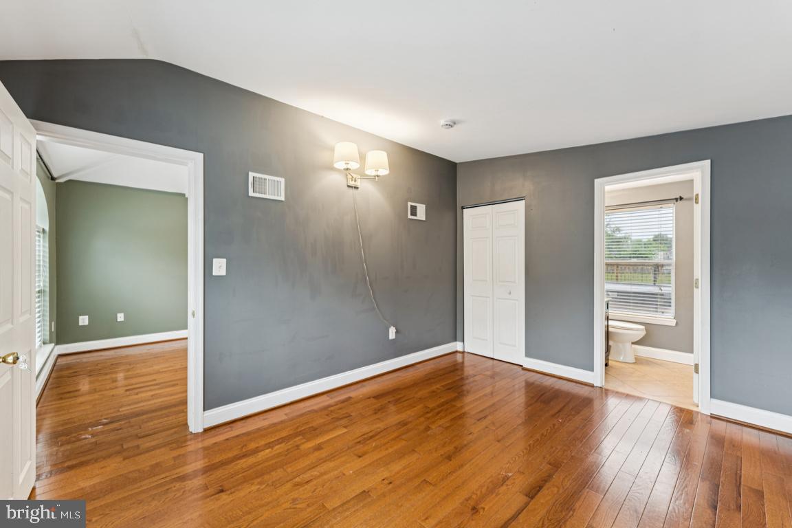 5 Brookfield Road Pasadena, MD 21122 - Photo 14 of 34 wooden floor in an empty room with a window