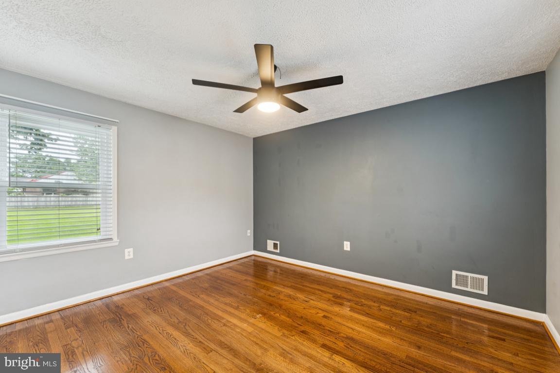 5 Brookfield Road Pasadena, MD 21122 - Photo 16 of 34 an empty room with wooden floor and windows