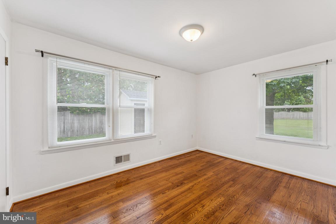 5 Brookfield Road Pasadena, MD 21122 - Photo 18 of 34 a view of an empty room with wooden floor and a window