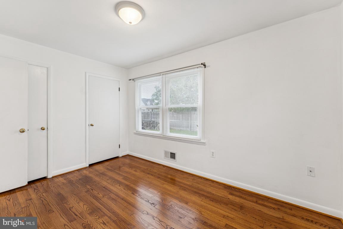 5 Brookfield Road Pasadena, MD 21122 - Photo 19 of 34 a view of an empty room with wooden floor and a window