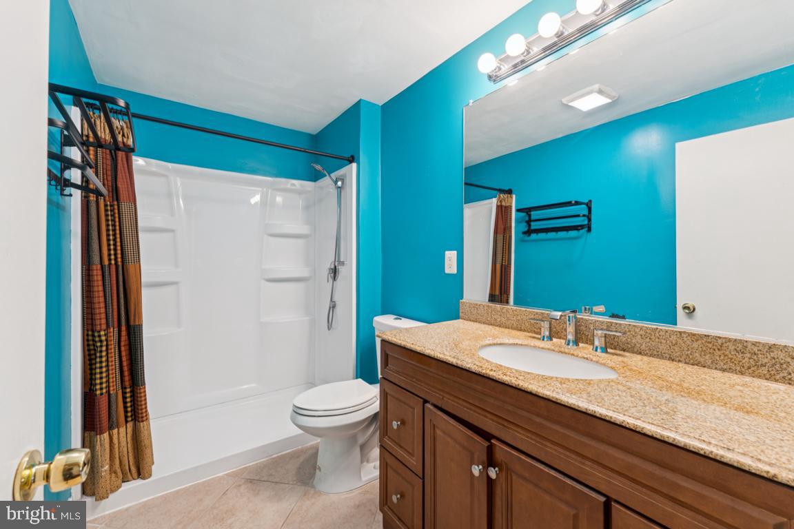 5 Brookfield Road Pasadena, MD 21122 - Photo 21 of 34 a bathroom with a granite countertop sink toilet and shower
