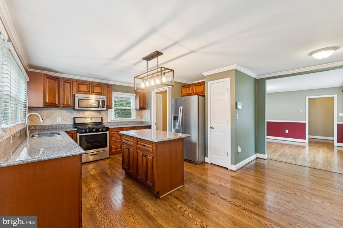 5 Brookfield Road Pasadena, MD 21122 - Photo 3 of 34 a kitchen with stainless steel appliances granite countertop a stove a sink and a refrigerator