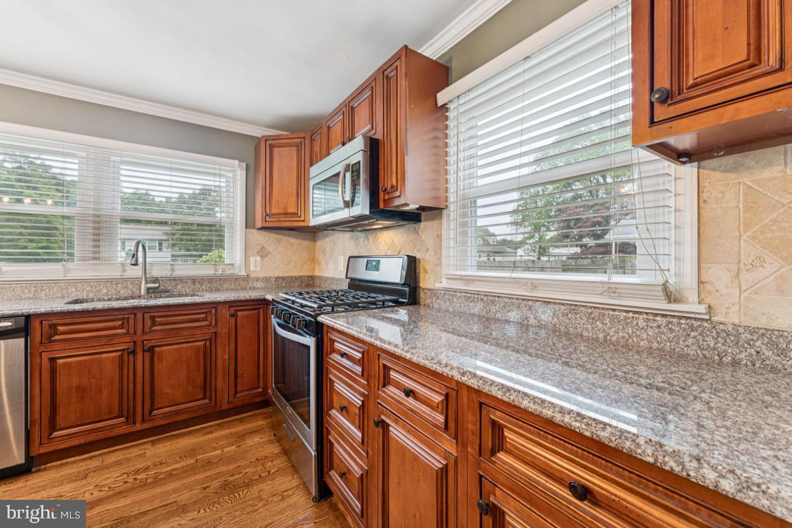 5 Brookfield Road Pasadena, MD 21122 - Photo 7 of 34 a kitchen with stainless steel appliances granite countertop a sink and a stove