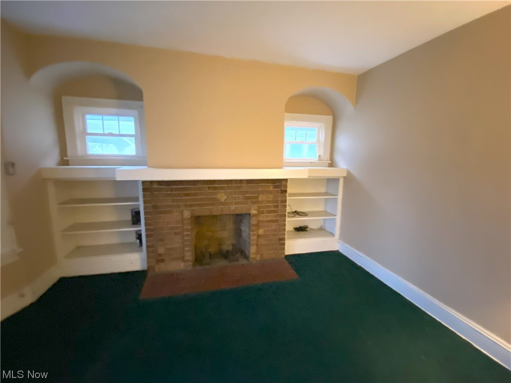 3650 Hildana Road Cleveland, OH 44120 - Photo 9 of 20 Unfurnished living room with dark colored carpet and plenty of natural light