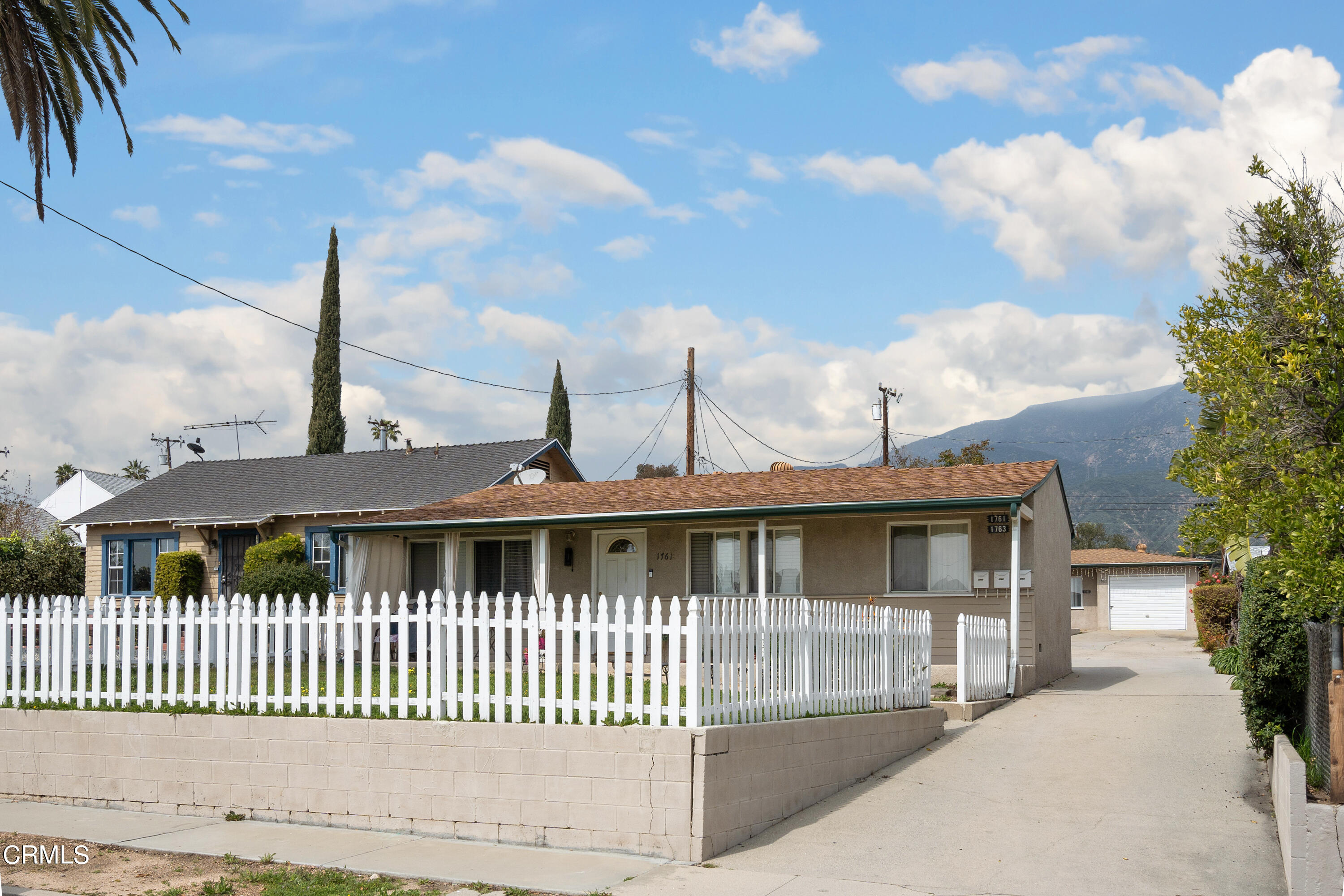 a front view of a house with a wooden fence