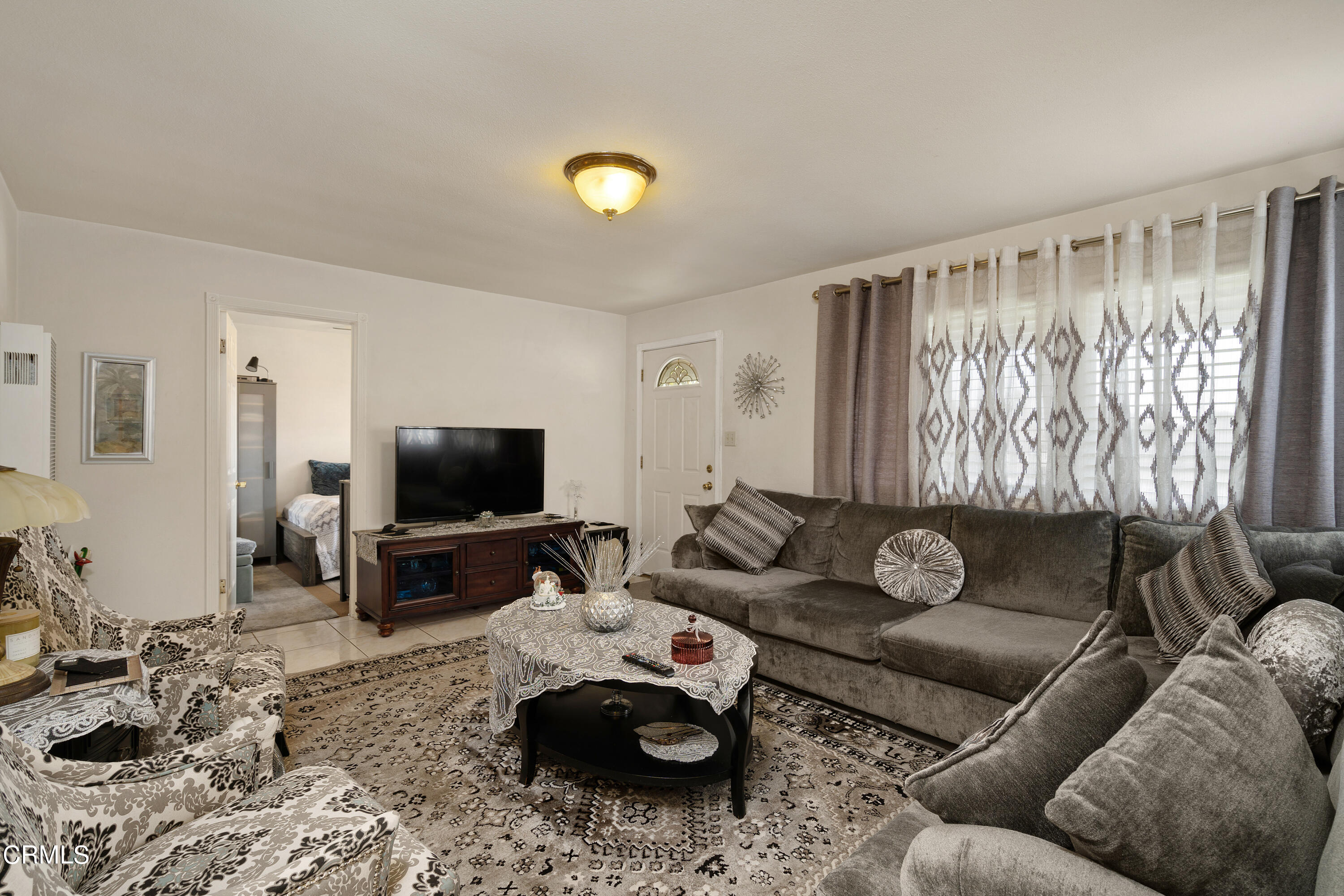 1761 Atchison Street Pasadena, CA 91104 - Photo 7 of 30 a living room with furniture and a flat screen tv