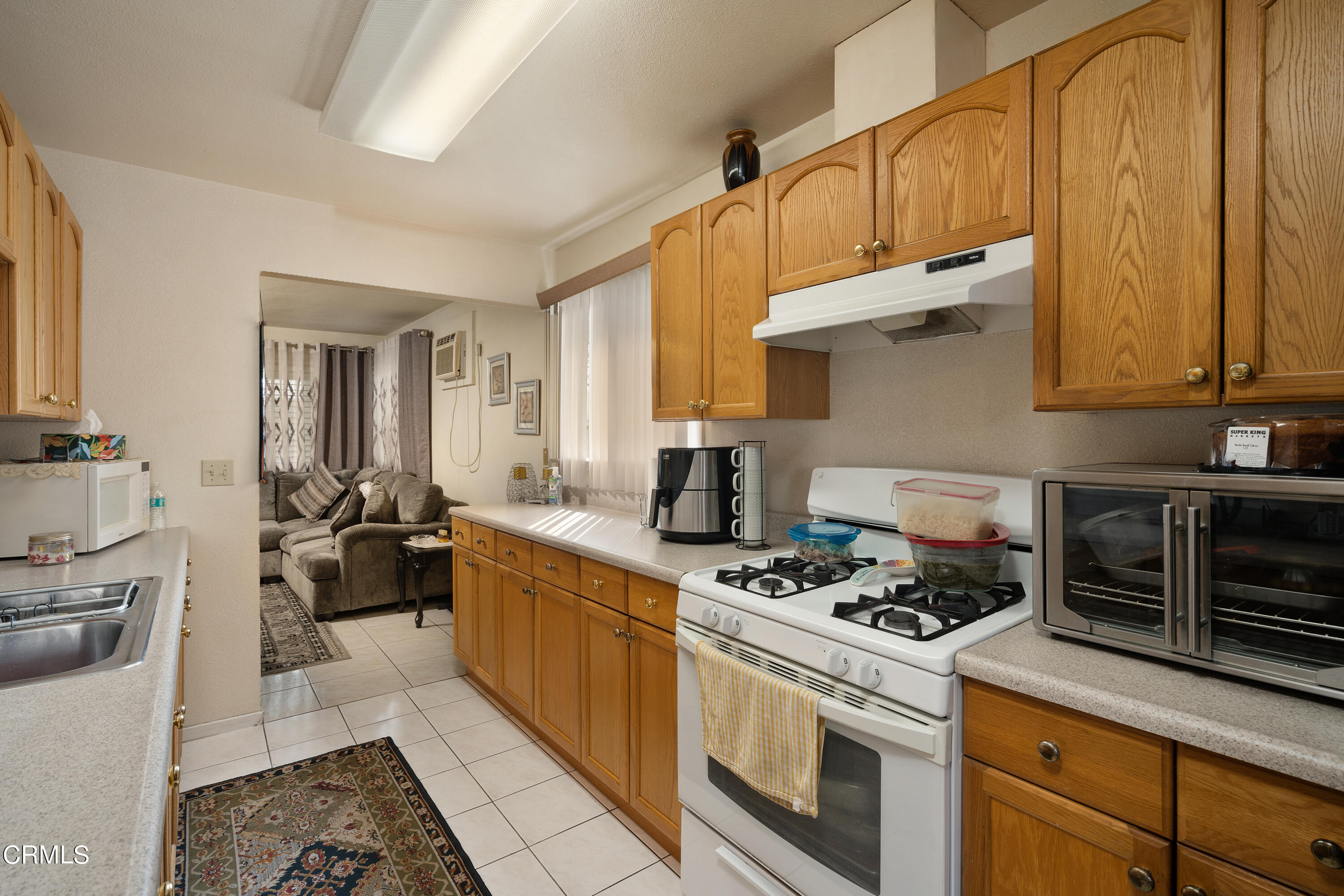 1761 Atchison Street Pasadena, CA 91104 - Photo 9 of 30 a kitchen with a stove a sink and a cabinets