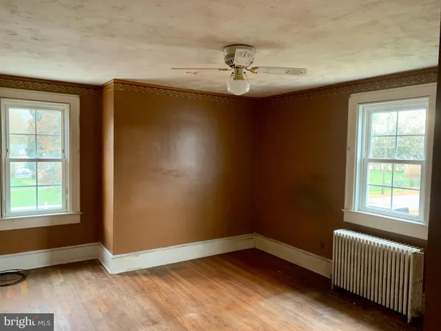 an empty room with windows and closet