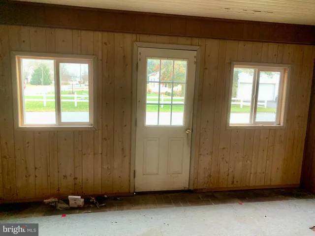an empty room with a window and a ceiling fan