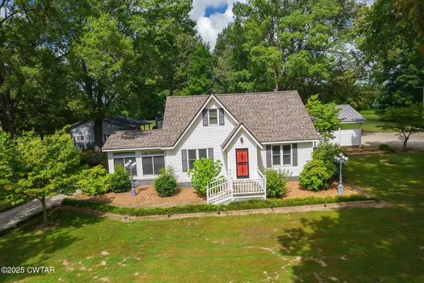 a front view of house with yard and green space