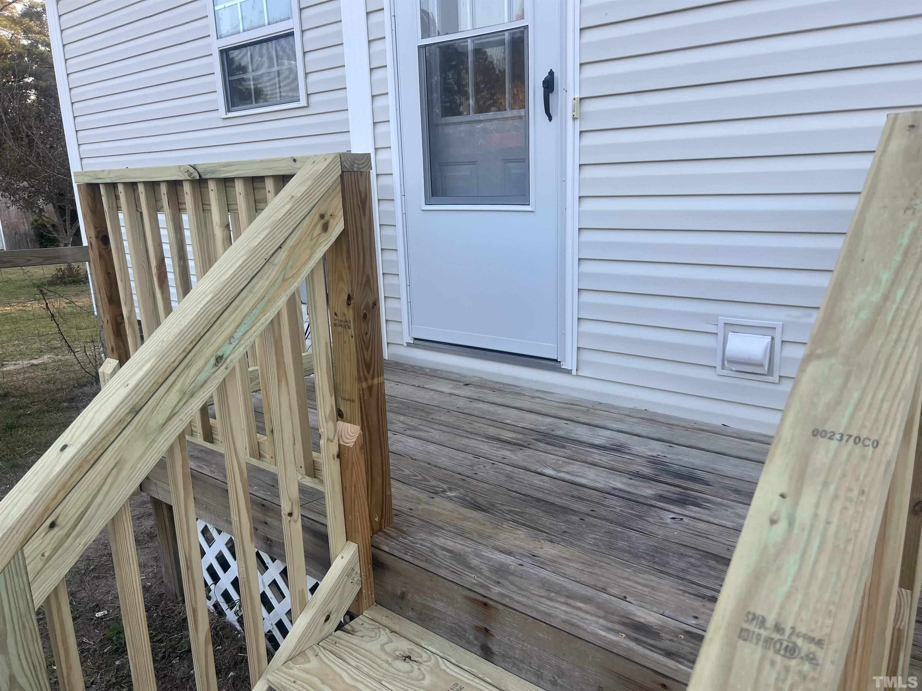 1219 Ridge Road Benson, NC 27504 - Photo 16 of 57 a view of balcony with wooden floor and stairs