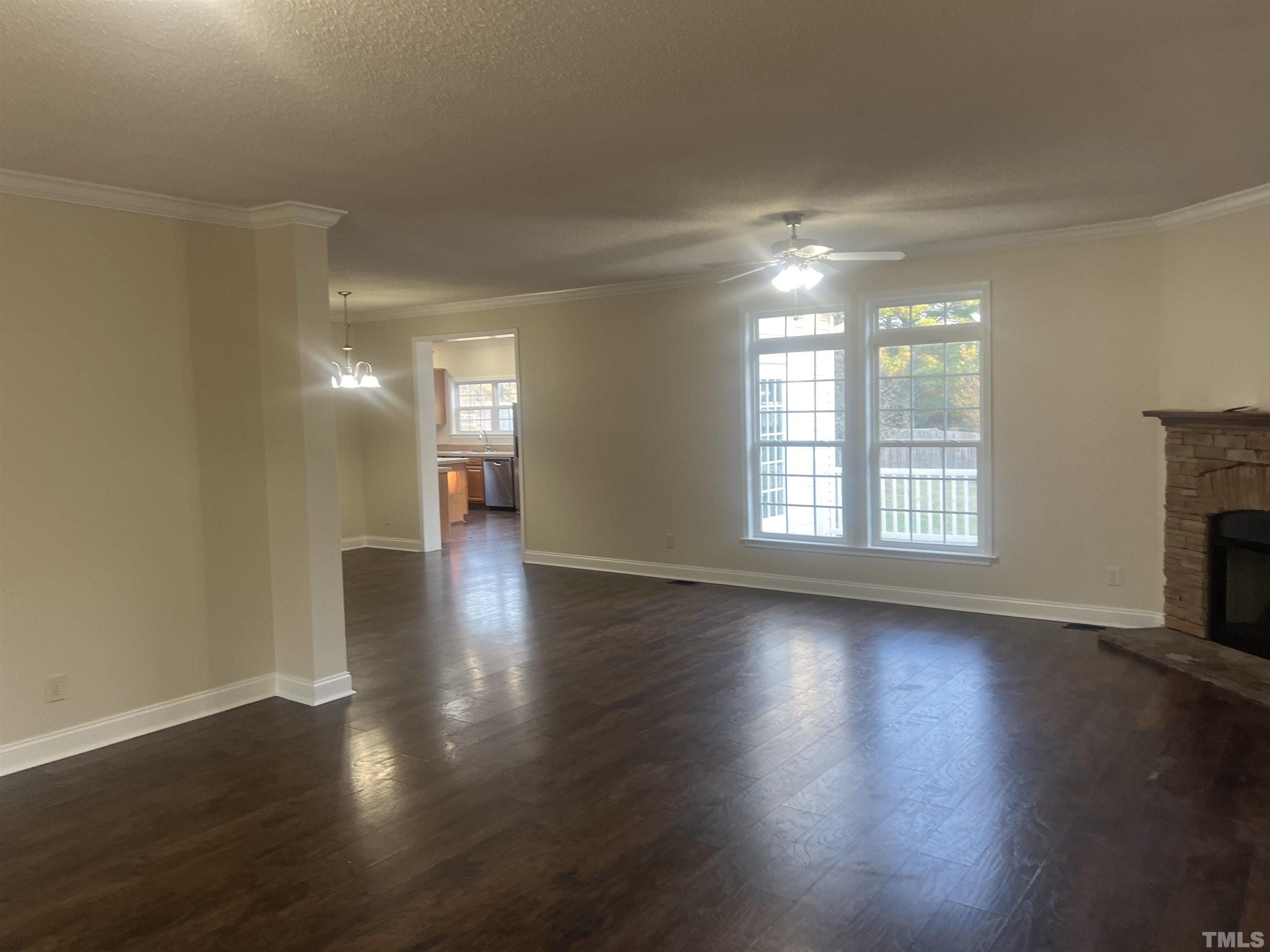 1219 Ridge Road Benson, NC 27504 - Photo 20 of 57 a view of an empty room with wooden floor and a window