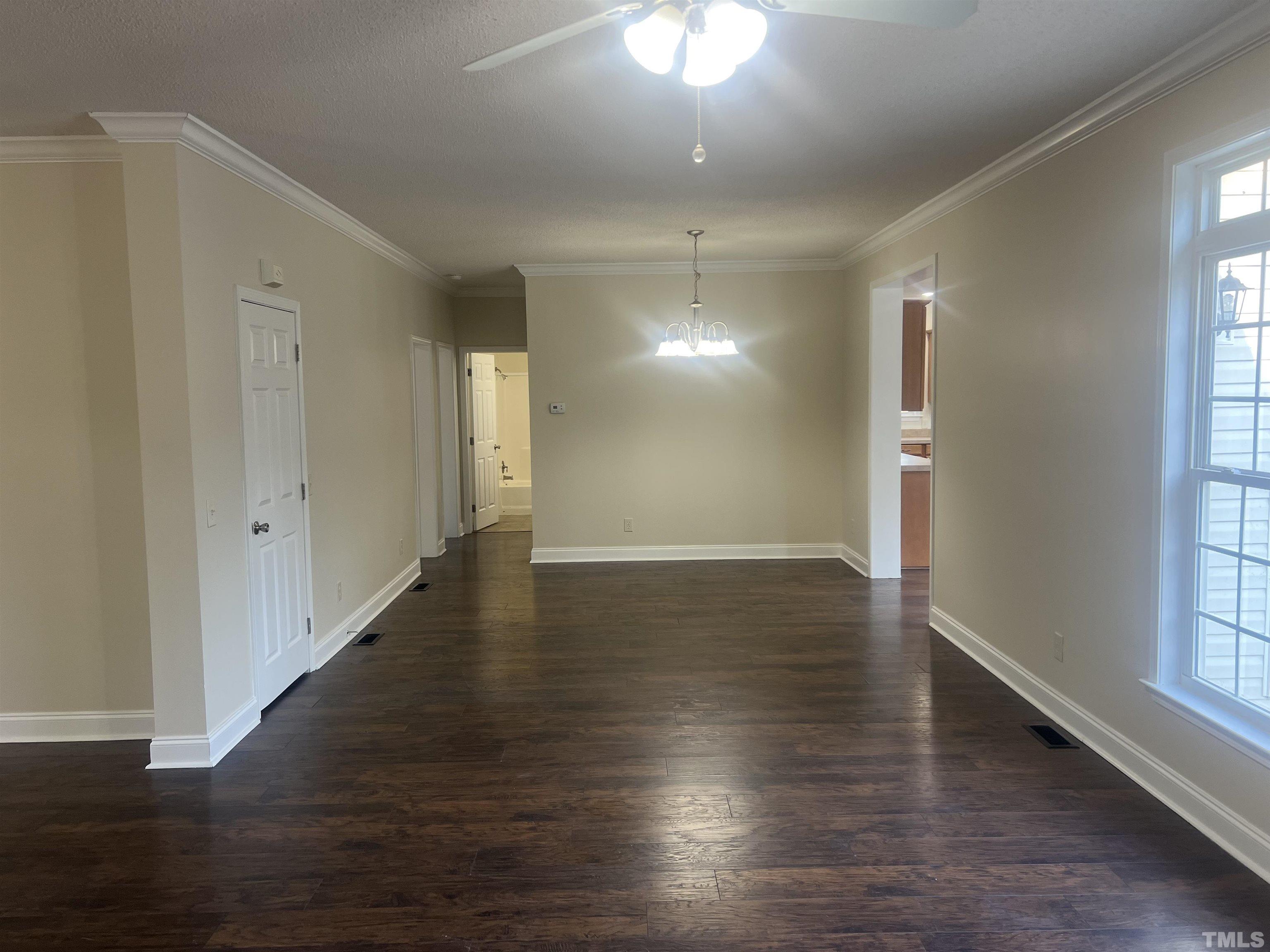 1219 Ridge Road Benson, NC 27504 - Photo 24 of 57 an empty room with wooden floor and windows