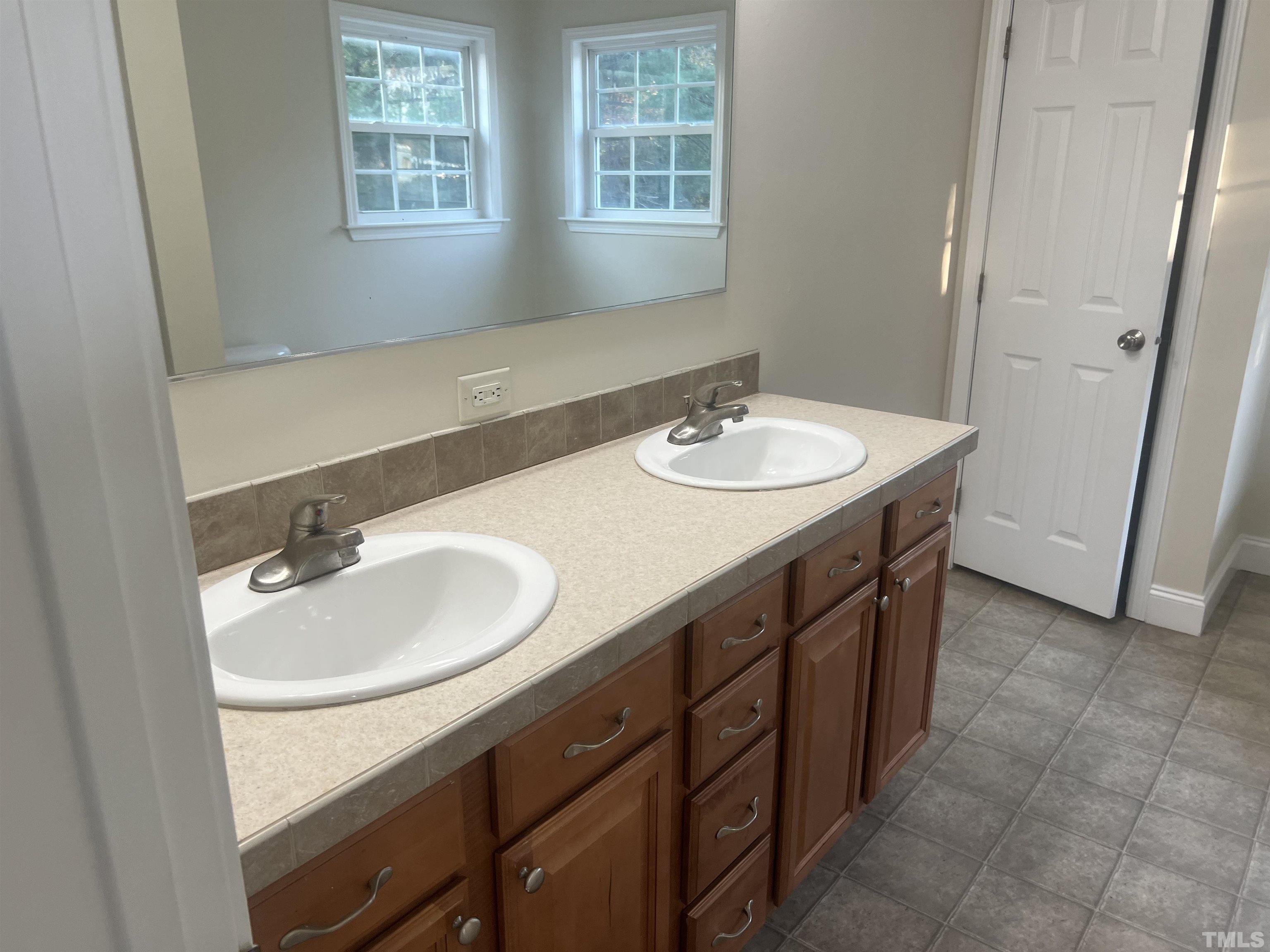 1219 Ridge Road Benson, NC 27504 - Photo 35 of 57 a bathroom with a sink and a mirror