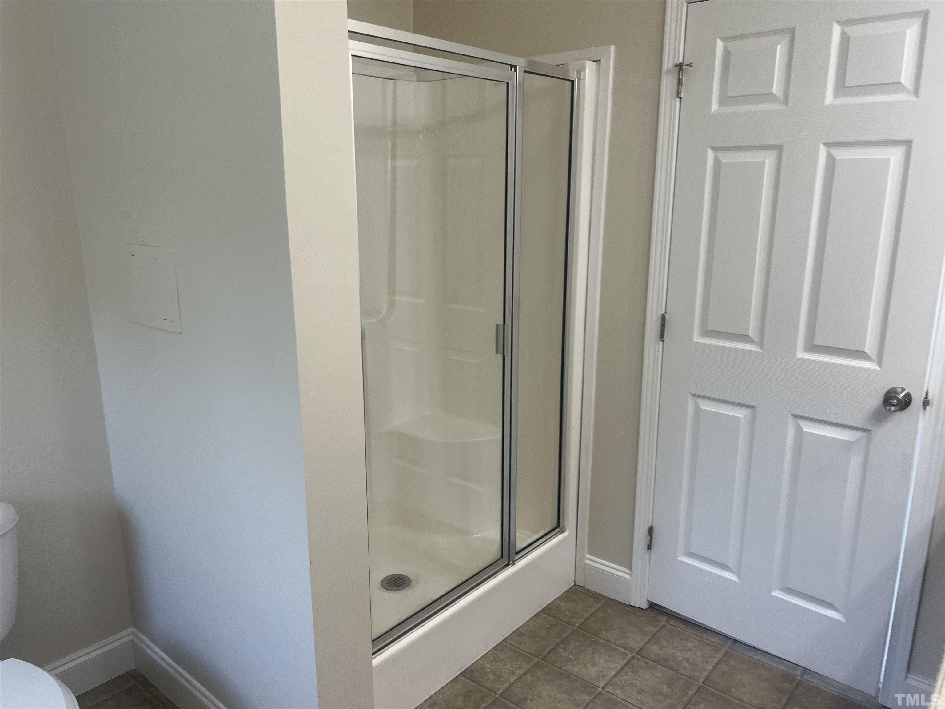 1219 Ridge Road Benson, NC 27504 - Photo 37 of 57 a bathroom with a glass door shower
