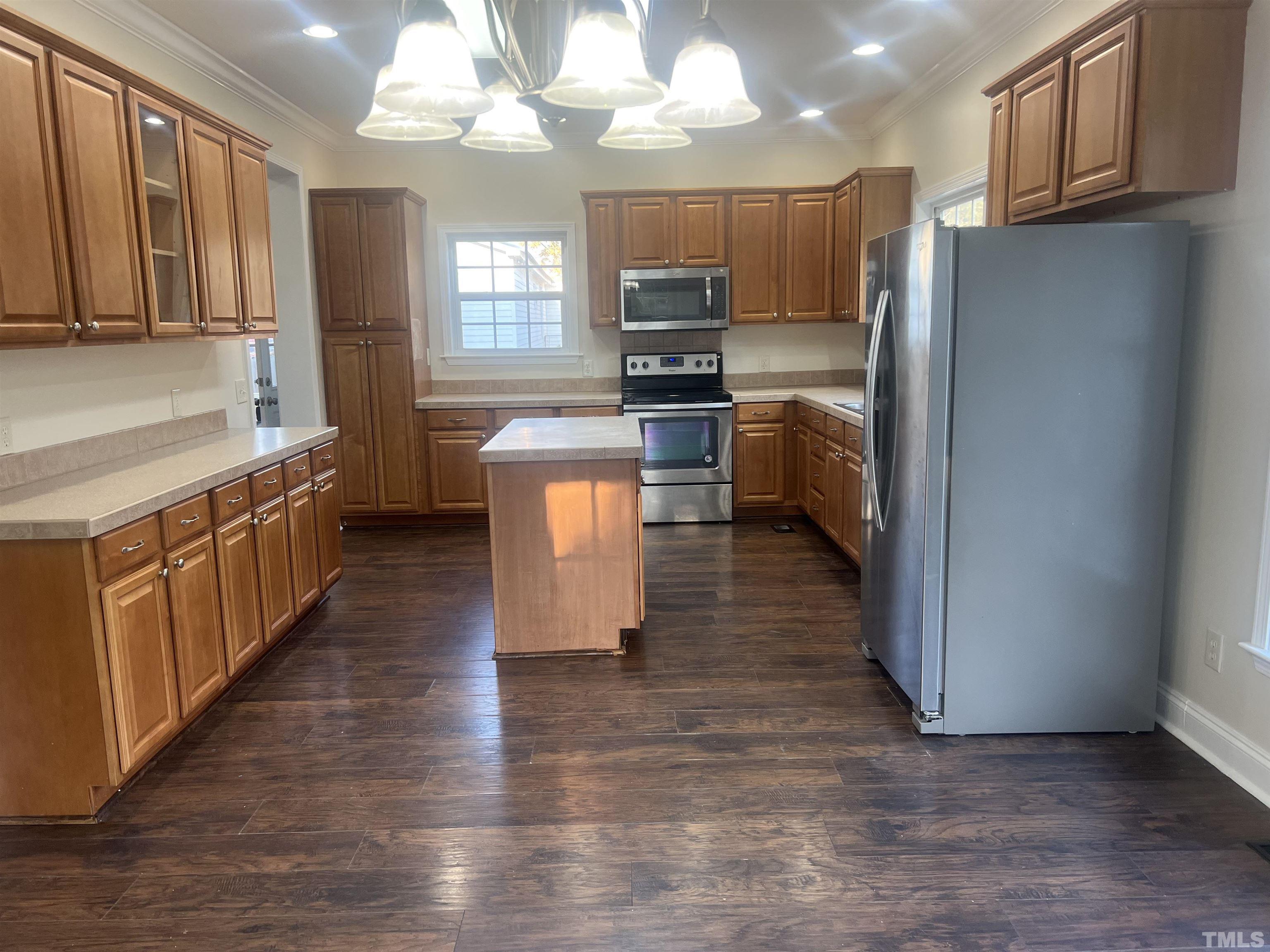 1219 Ridge Road Benson, NC 27504 - Photo 41 of 57 a kitchen with stainless steel appliances a refrigerator sink and cabinets