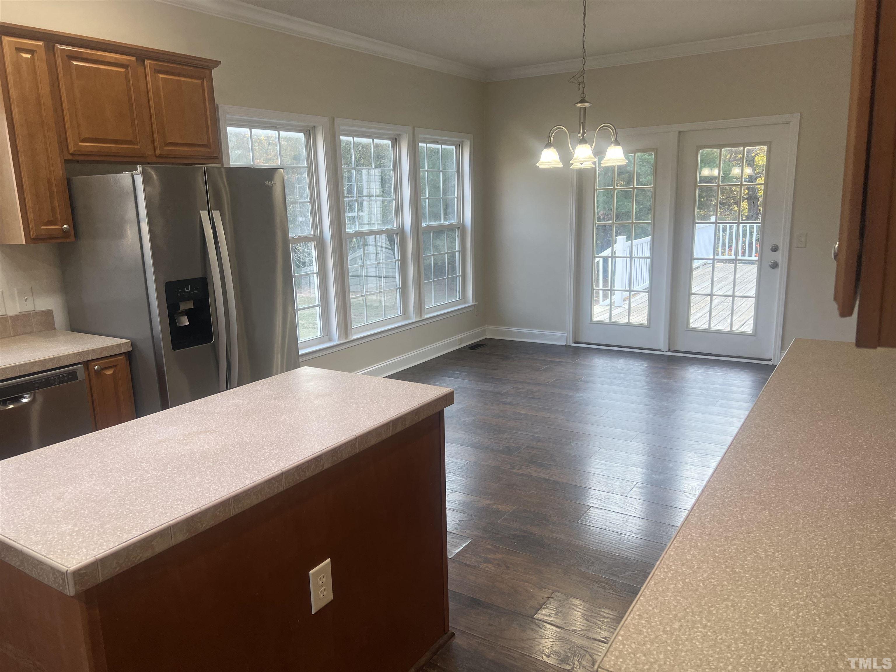 1219 Ridge Road Benson, NC 27504 - Photo 46 of 57 a kitchen with stainless steel appliances wooden floor and large window