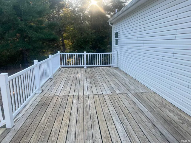 a view of a backyard with large trees