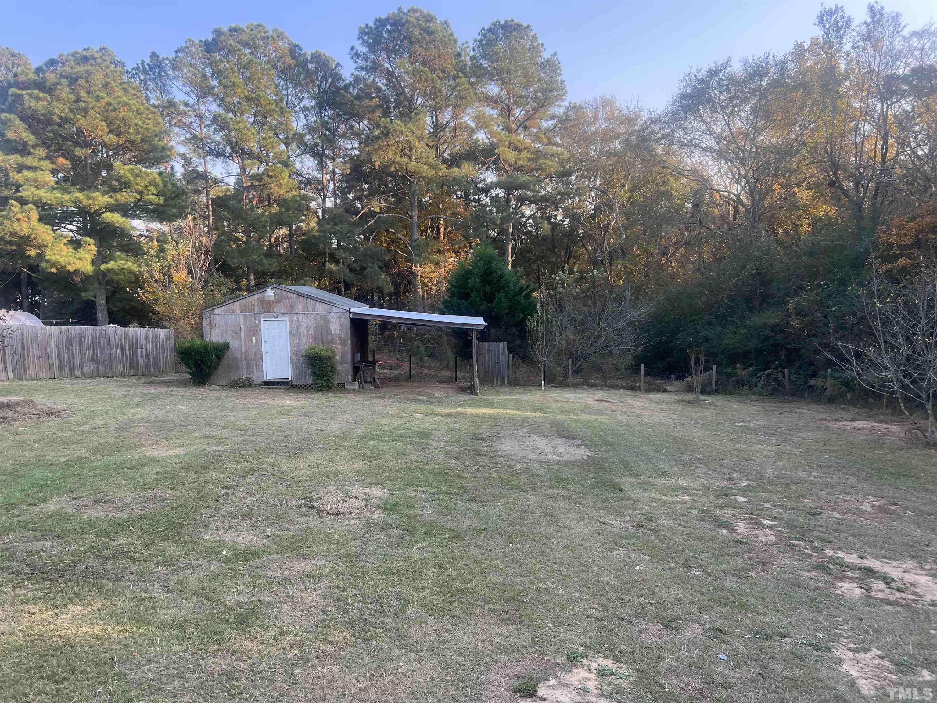 1219 Ridge Road Benson, NC 27504 - Photo 8 of 57 a view of a backyard with large trees