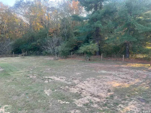 a view of a house with backyard swimming pool and sitting area