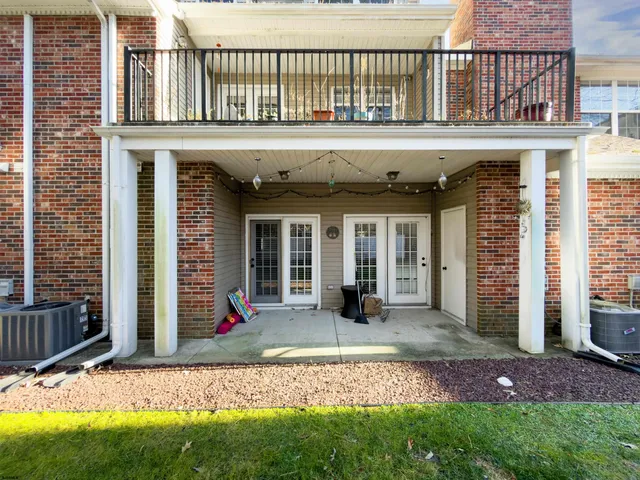 a front view of a house with a yard outdoor seating and barbeque oven