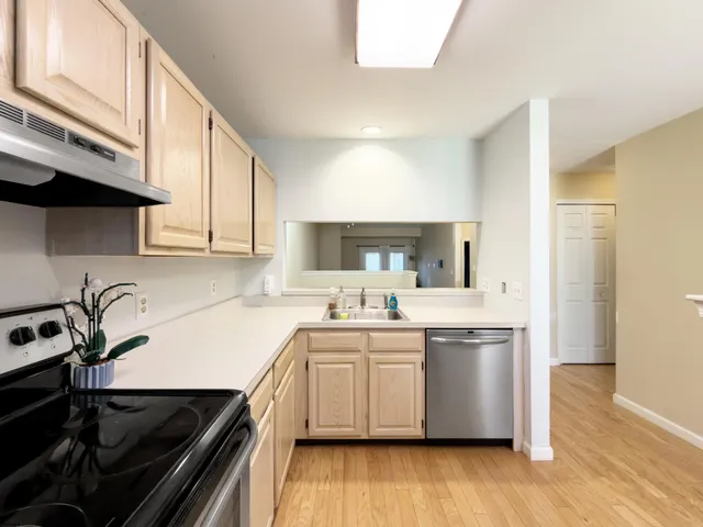 a kitchen with a sink a stove and cabinets