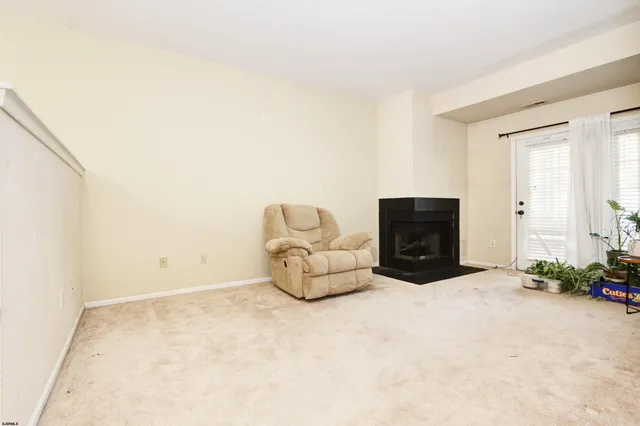 an empty room with a fireplace and a window