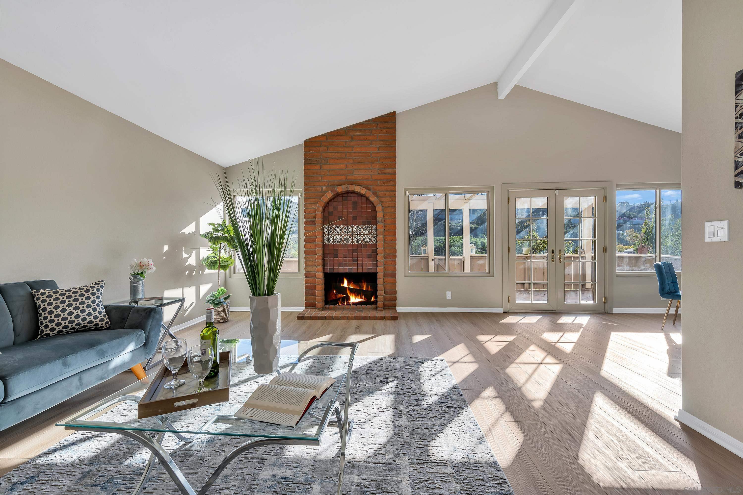 a living room with furniture and a floor to ceiling window