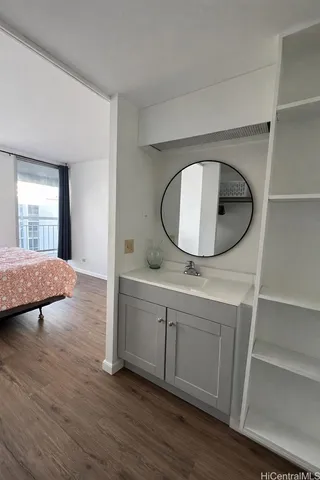 an entryway with wooden floor and a sink
