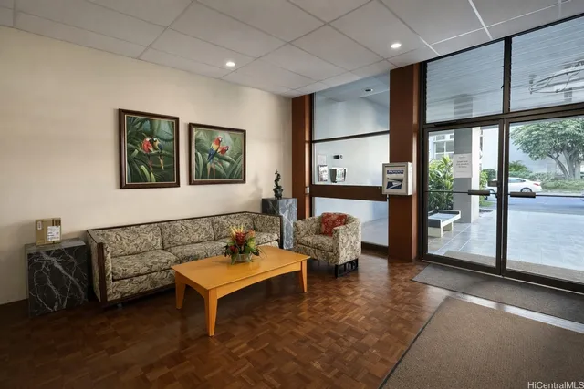 a living room with furniture and a floor to ceiling window