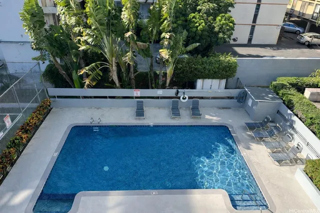 swimming pool view with a seating space