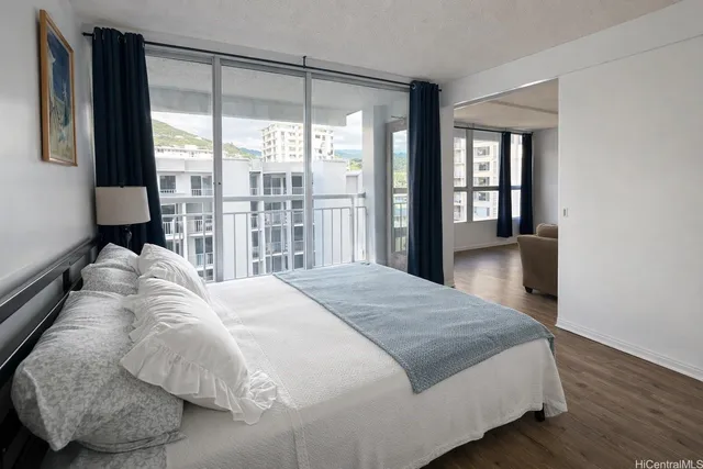 a bedroom with a bed and a large window