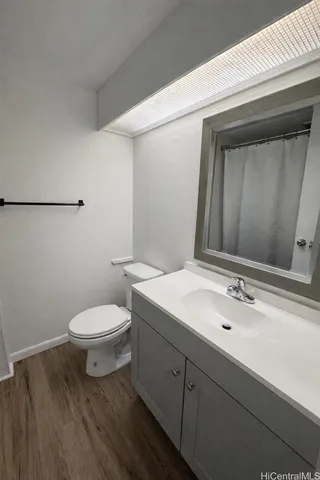 a bathroom with a sink a toilet and mirror