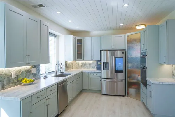 a kitchen with a stove and a white cabinets