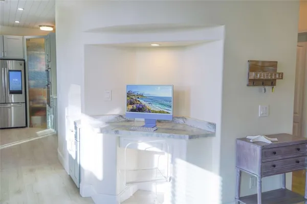 a view of entryway livingroom and hall with wooden floor