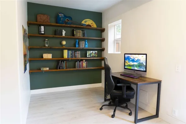 a bath room with a sink and a mirror