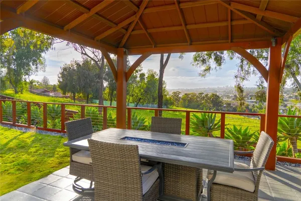 a view of a patio with couches chairs and a potted plant