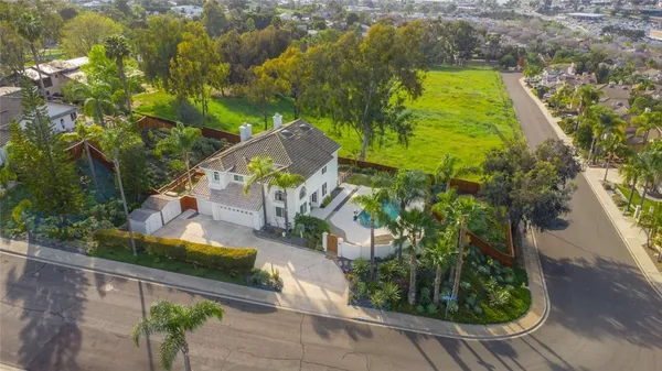 an aerial view of a house with garden space and sitting area
