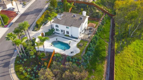 an aerial view of a house with a yard basket ball court and outdoor seating
