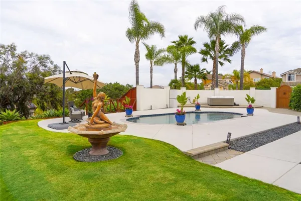 a view of a backyard with swimming pool