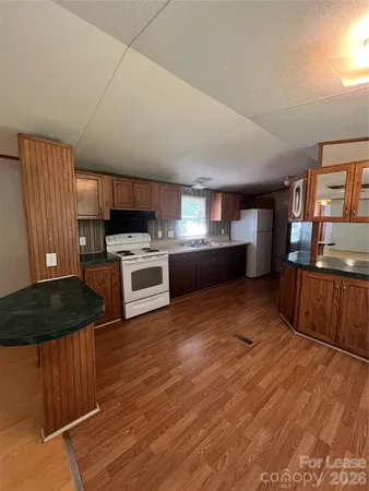 a kitchen with stainless steel appliances a stove a refrigerator sink and cabinets