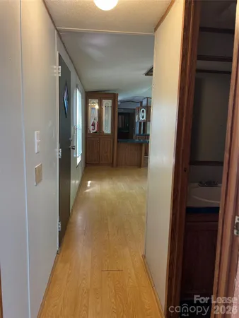 a view of hallway with livingroom and window