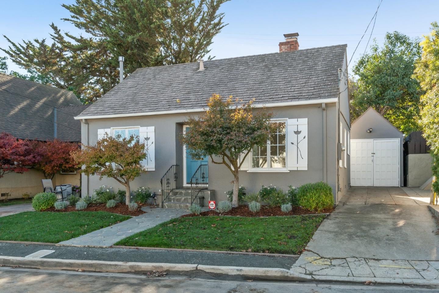 a front view of a house with garden